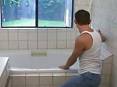 A dude in a bath is stroking his dick