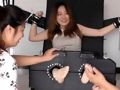 Helpless Asian babe has two friends tickling her sexy feet