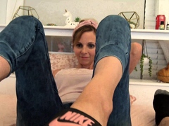 Sexy brunette milf in slippers gives a special POV footjob